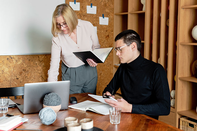 Foto: Ein Mann und eine Frau schauen auf einen Laptop.